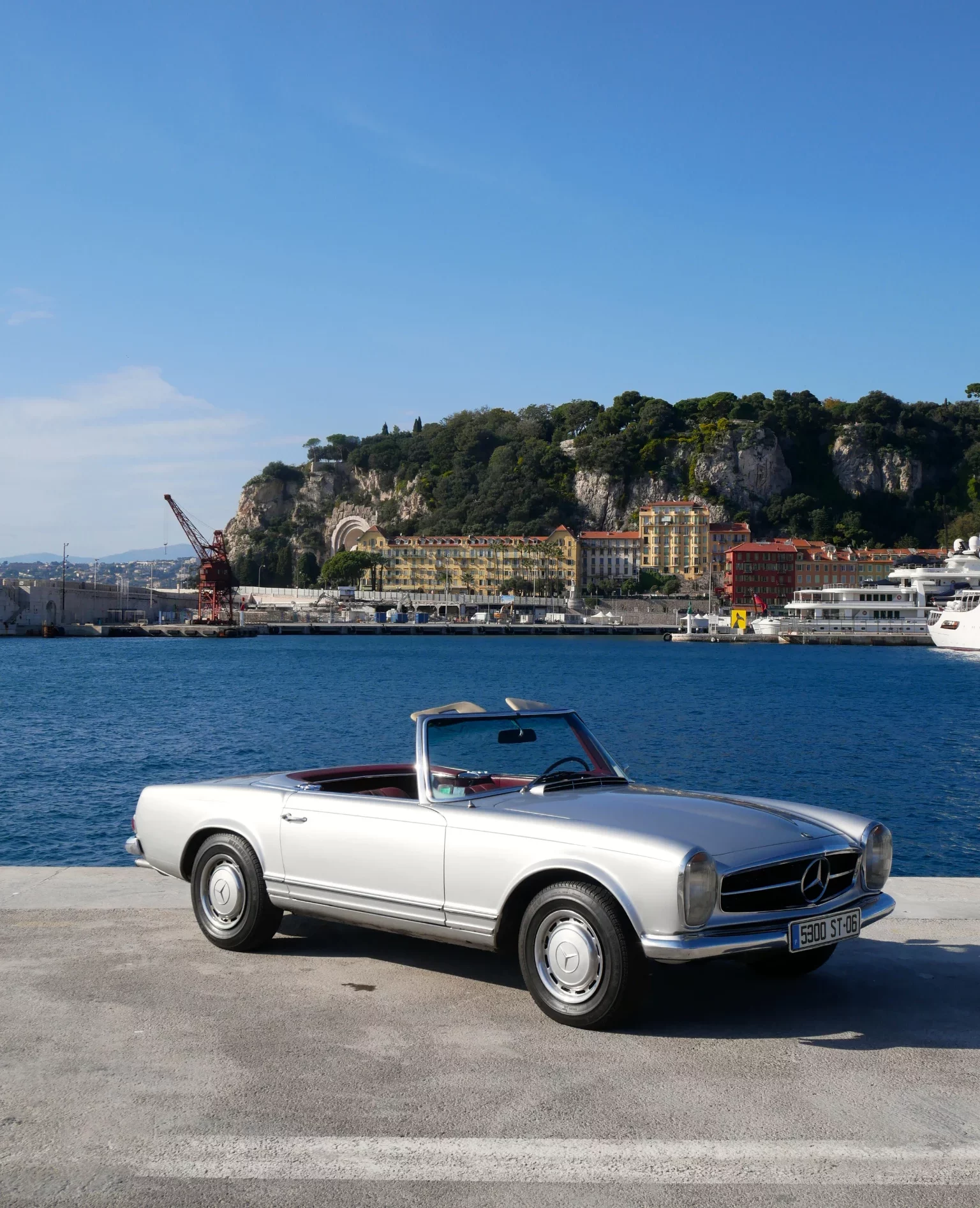 Silver Mercedes 280SL Pagode classic convertible car rental luxury.