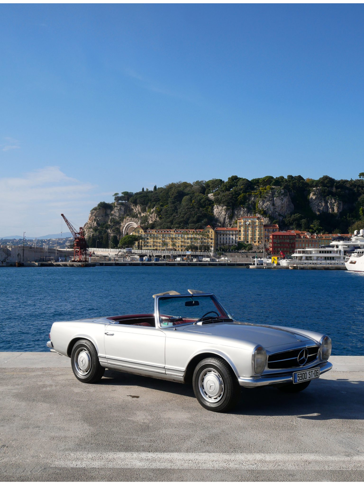 Silver Mercedes 280SL Pagode classic convertible car rental luxury.